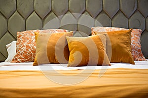 Close-up of a moddern bed with wool bedding and pillows