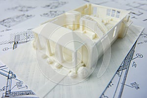 Close-up of model of the first floor of a family house printed on a 3D printer with white filament by FDM technology for