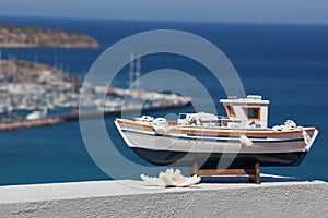 Close up of model ship by the sea.