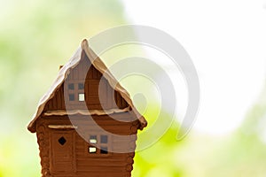 Close-up of a model of a village house on a blurred background. Space for lettering and design