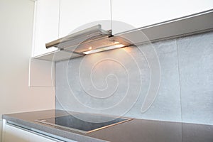 Close up on modern air exhauster kitchen fan or Range Hood. Stainless Steel Chimney Hood. Island Hoods.