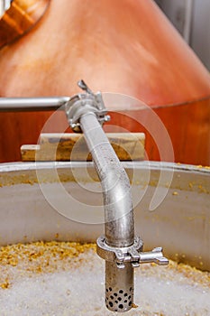 Close up of modern beer plant brewery , with brewing kettles, vessels, tubs and pipes made of stainless steel, in a beer
