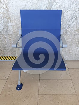 Close-up of modern Bench in the terminal of airport, blue tone. Empty airport terminal waiting chair