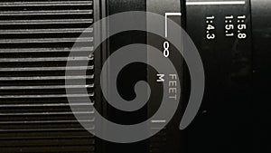 Close-up of a modern camera lens, turning of a zoom rings in shallow depth of field