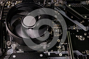 Close-up of modern computer motherboard with installed cpu and cooler. Electronic computer hardware technology