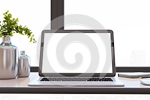 Close up of modern designer office desktop with white mock up computer display, decorative vase with plant, other objects and