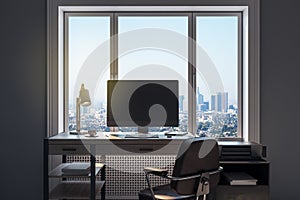 Close up of modern designer workplace in modern office interior with blank mock up computer screen, window with beautiful city