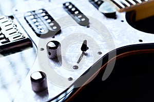 Close up of modern electric guitar on black background.