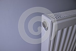 Close up of Modern radiator on grey wall indoors. Central heating system