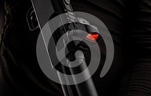 Close-up of a modern reflex sight mounted on a shotgun. Aiming device for marksmanship. Dark back photo