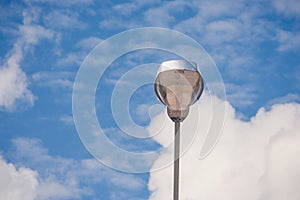 Modern stree lamp located on concrete floor beside road with blue sky background. photo
