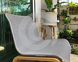 Close up modern textile chair at house terrace with garden