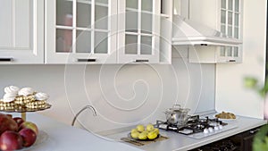 Close-up of a modern white and gray kitchen interior. Modern kitchen interior: black bottom, white top.