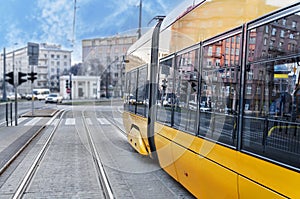 Close up of a modern yellow tram in the rails