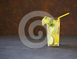 Close up of mojito cocktail in the glass on dark background