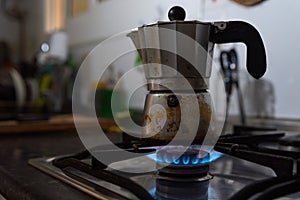 In this close up a moka is seen on top of a kitchen stove with a blue gas flame. Due to Russia`s invasion of Ukraine gas prices