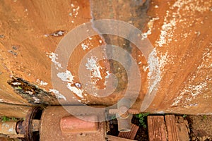 Close-up Moldy Old PVC Valve on Dirty Concrete Wall with Vintage Rusty Water Turbine Generator