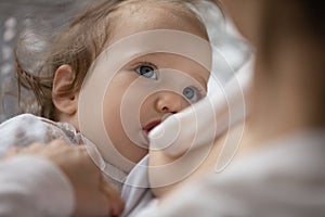 Close up of mom breastfeed newborn baby daughter photo