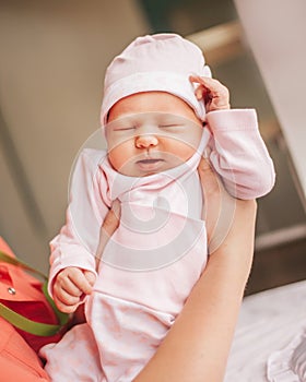 Close up. mom dressing her newborn baby for a walk.