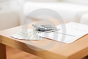 Close up of money and calculator on table at home