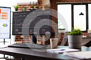 Close up of monitor with company growth analysis on office desk
