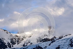 The close-up of Mont Blanc du Tacul in the clouds in Europe, in France, in the Alps, towards Chamonix, in summer