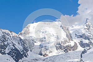 The close-up of Mont Blanc du Tacul surrounded by clouds in the Mont Blanc Massif in Europe, France, the Alps, towards Chamonix,