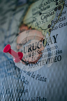 Close up of Montevideo pin pointed on the world map with a pink pushpin
