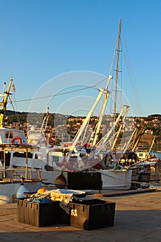 Close up of the moored fishing boats in harbor of Koper. Mooring of the small fishing vessel at the dock