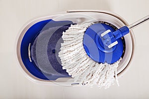 Close up of mop and blue bucket for cleaning floor