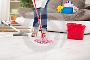 Close up of mop, housewife with mop cleans floor