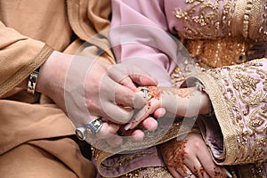 Close up of moroccon couple's hands at a wedding, concept of marriage, photo
