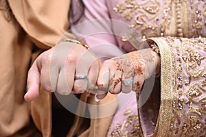 Close up of moroccon couple's hands at a wedding, concept of marriage, photo