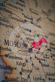 Close up of Moscow pin pointed on the world map with a pink pushpin