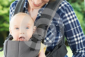Close Up Of Mother With Baby Daughter In Carrier