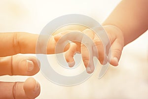Close-up of mother and baby's hands