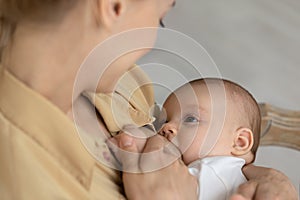 Close up of mother breastfeed baby infant photo