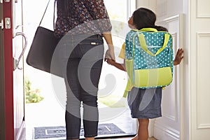 Close Up Of Mother And Daughter Leaving For School