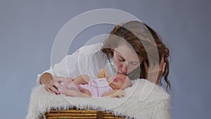 Close up mother gently kissing baby enjoying loving mom playfully caring for toddler sharing connection with her newborn