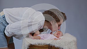 Close up mother gently kissing baby enjoying loving mom playfully caring for toddler sharing connection with her newborn