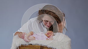 Close up mother gently kissing baby enjoying loving mom playfully caring for toddler sharing connection with her newborn
