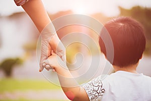 Close up mother holding a child`s hand.