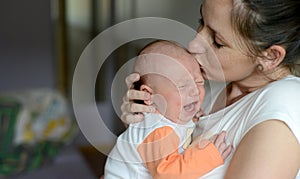 Close up of mother holding her cute baby daughter