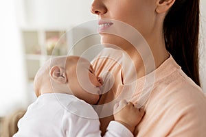 Close up of mother holding sleeping baby