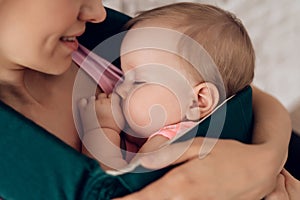 Close up. Mother holding sleeping baby.