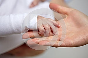 Close up of mother and newborn baby hands