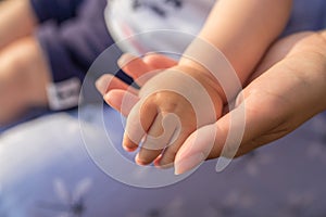 Close up mother`s hand hand her baby. Love family healthcare and medical body part mother`s day concept