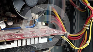 Close-up of a motherboard and a system unit fan that has not been used for a long time