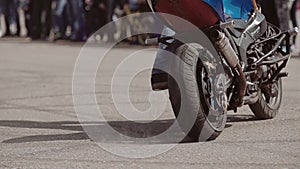 Close-up of a motorcycle and a motorcyclist during the performance of a cool Moto trick. Torsion of the motorcycle.
