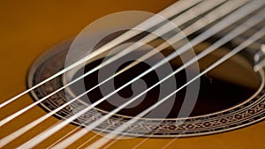 Close-up of the strings of a classical acoustic guitar photo